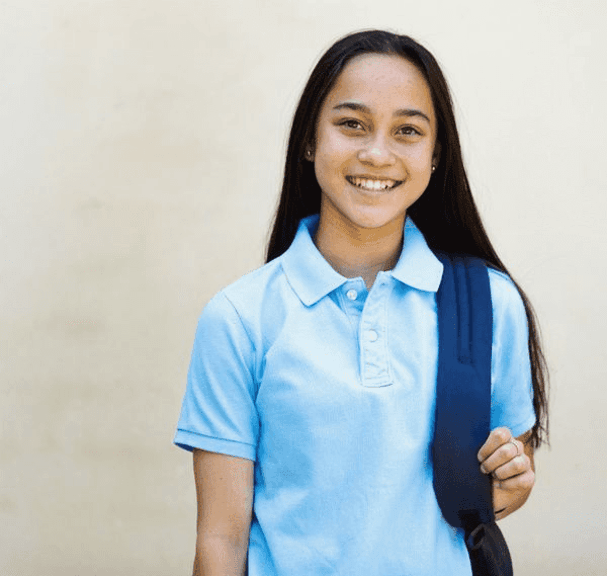A smiling student in a school uniform